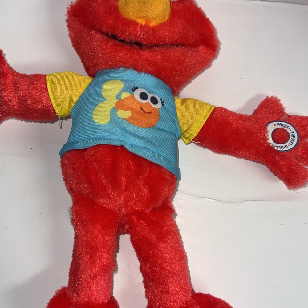 Red Plush Toy with Blue and Yellow Shirt